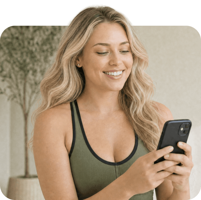 A smiling woman checking her phone