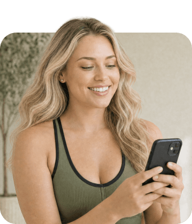 A smiling woman checking her phone